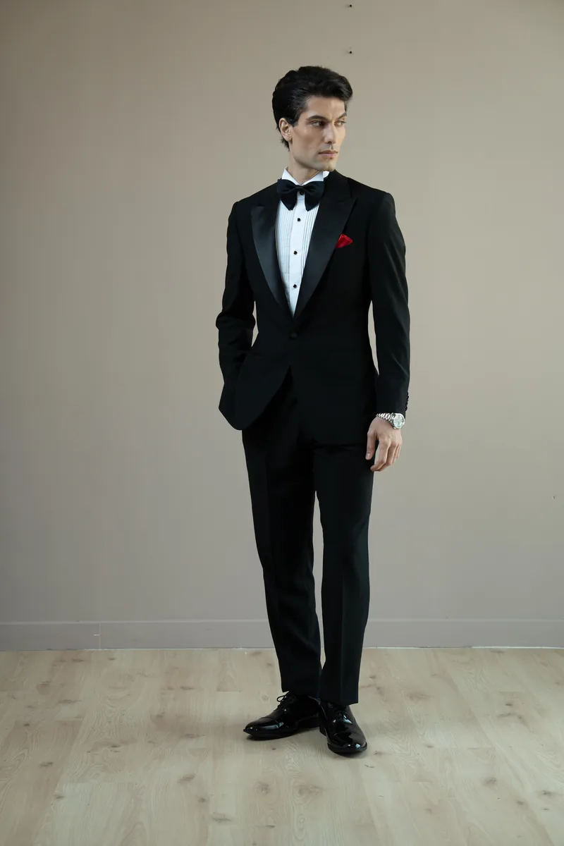 Full black-tie look with a bespoke tuxedo, white dress shirt and black bow tie