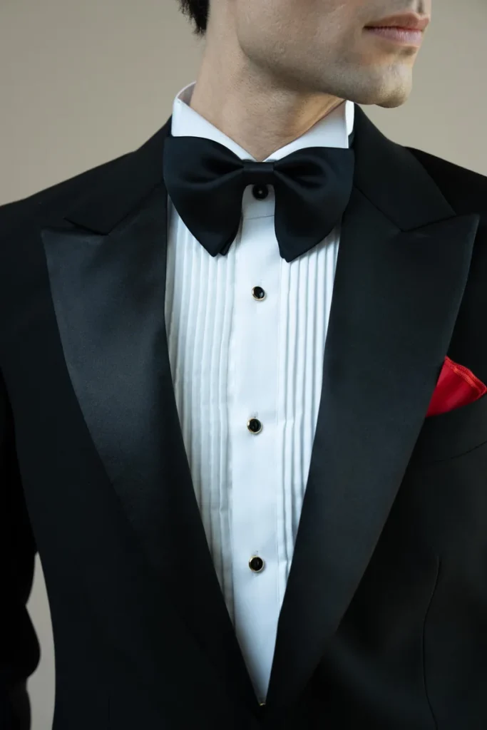 Black satin tuxedo lapel and bow tie with a pleated white dress shirt
