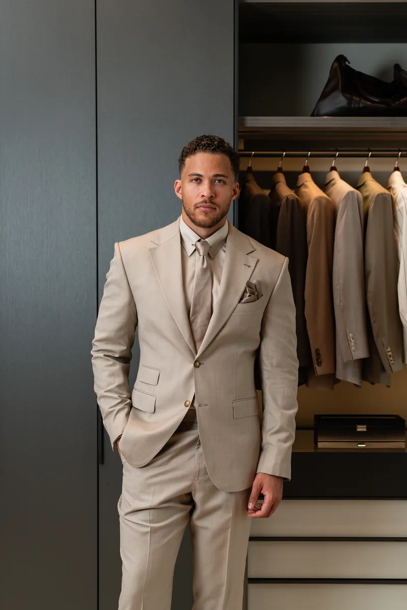 Light taupe two-piece wedding suit for a groom with a tonal tie and pocket square